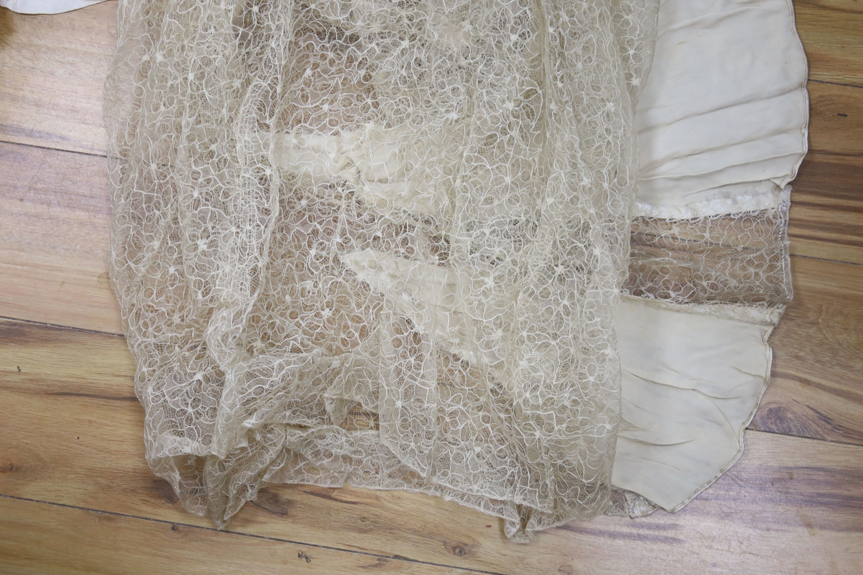 A 1930's lace and satin wedding dress including net veil